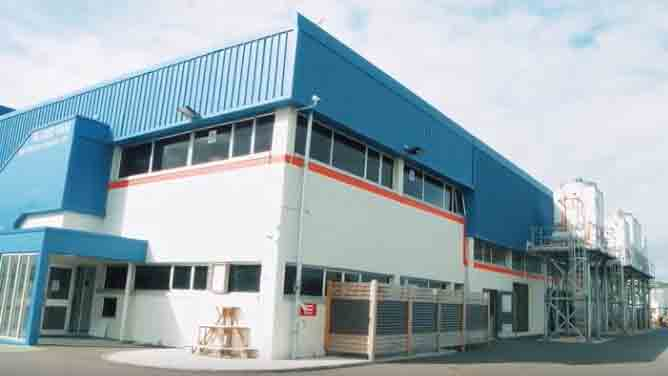 Exterior of a modern blue and white ice cream factory building
