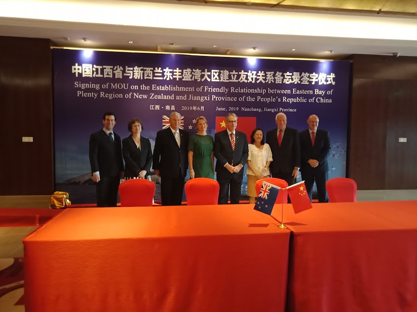 Bay of Plenty mayors and embassy staff standing at a signing ceremony in Nanchang