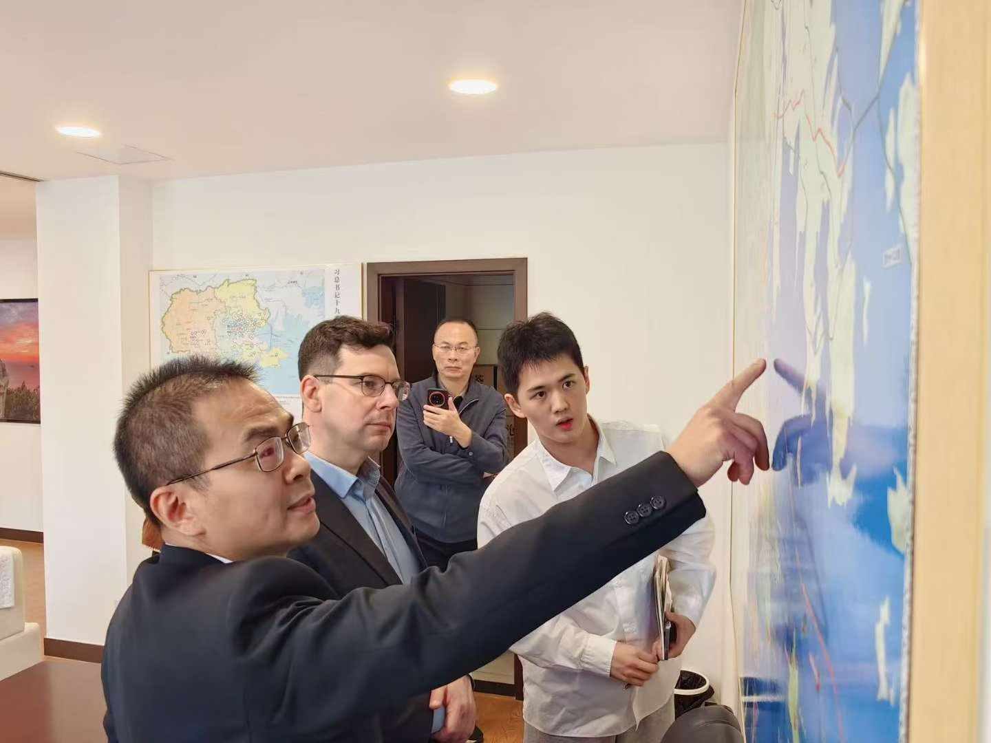 Simon Appleton reviewing plans and documents with partners during a due-diligence visit