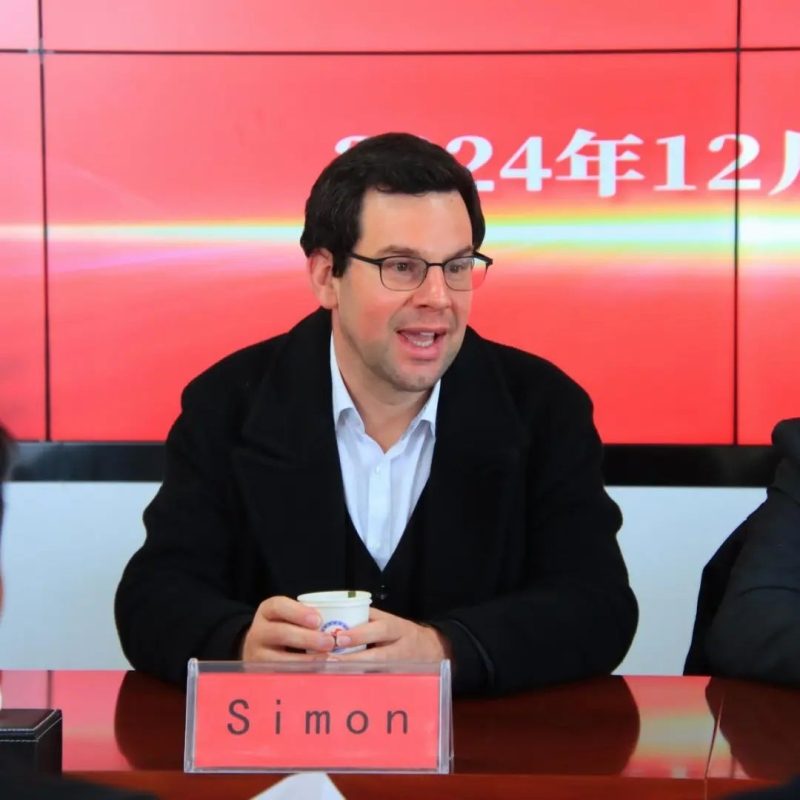 Simon Appleton seated at a forum in China