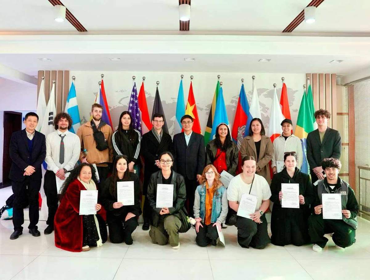 New Zealand volunteers with host-school teachers at a graduation ceremony in Nanchang, Jiangxi