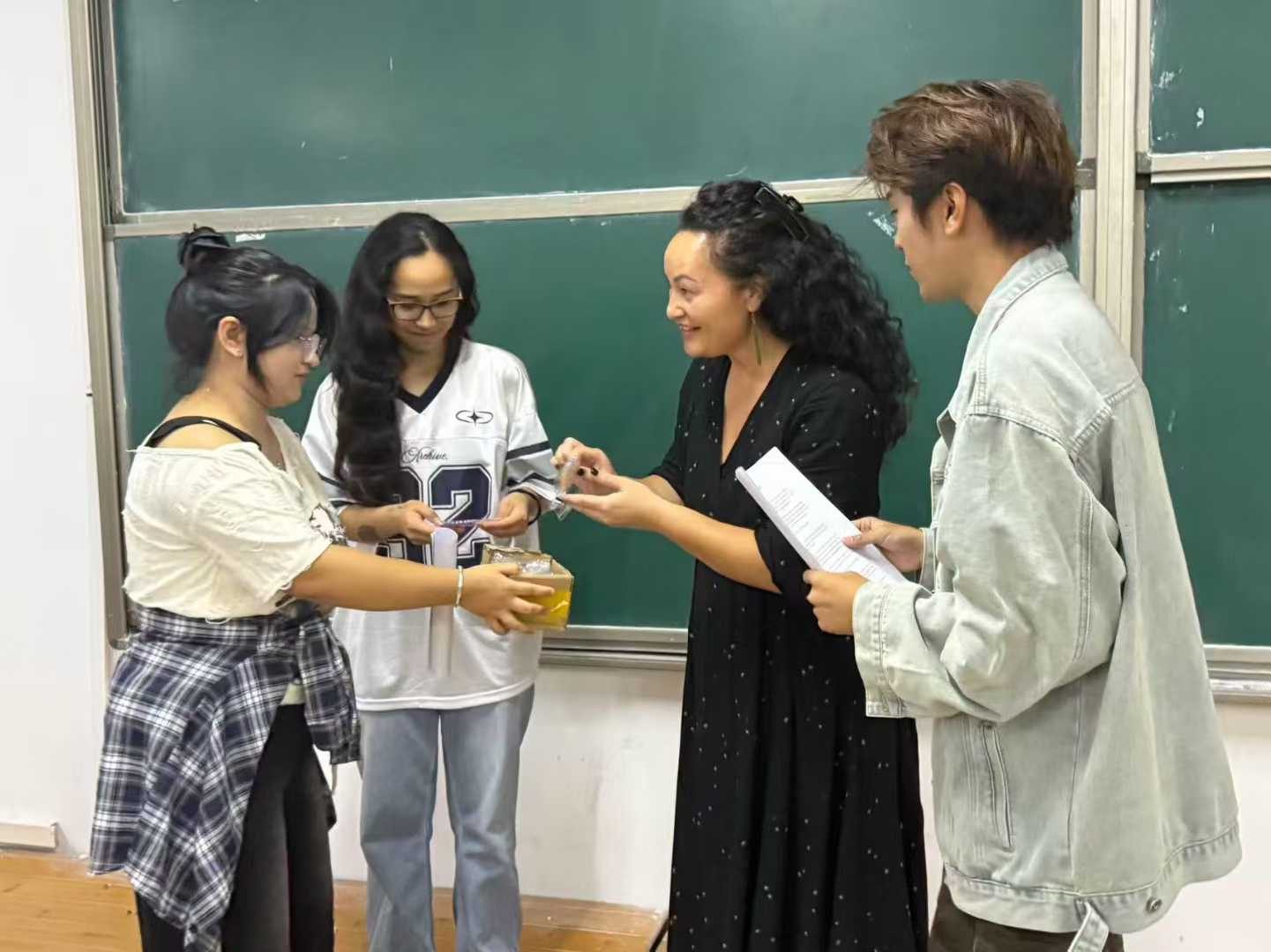 Volunteers chatting with host-school students in a classroom in Jiangxi