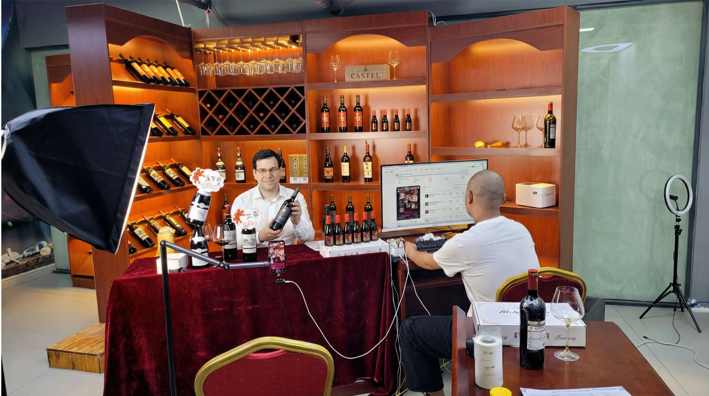 A livestream presenter promoting wine in front of shelves of bottles